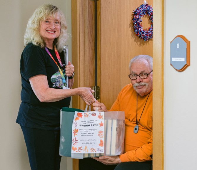 Outreach librarian Connie Ament delivering library materials to outreach patron